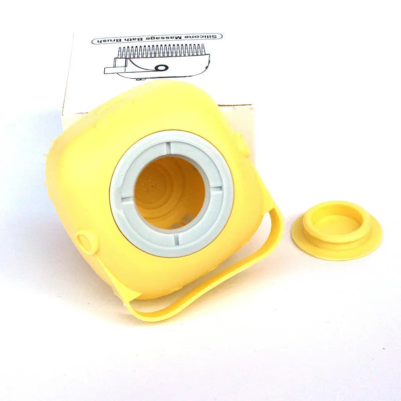 Yellow silicone massage bath brush with removable cap and packaging on white background