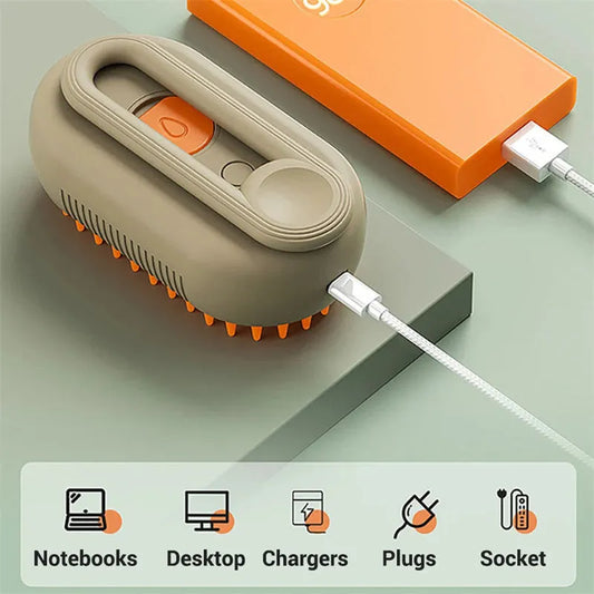 Portable handheld electric scalp massager with silicone bristles and USB charging cable on green surface