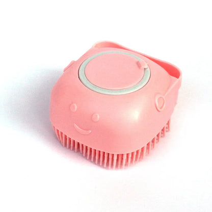 Pink silicone facial cleansing brush with smiley face and soft bristles on white background