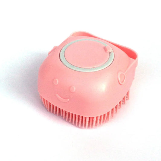 Pink silicone facial cleansing brush with smiley face and soft bristles on white background