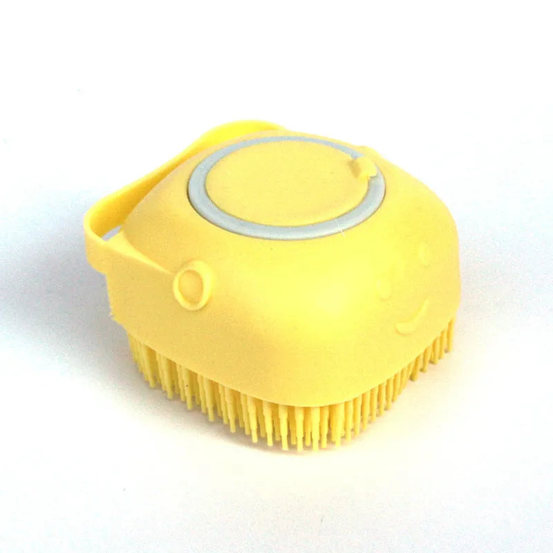 Yellow silicone pet grooming brush with soft bristles and a smiling face design